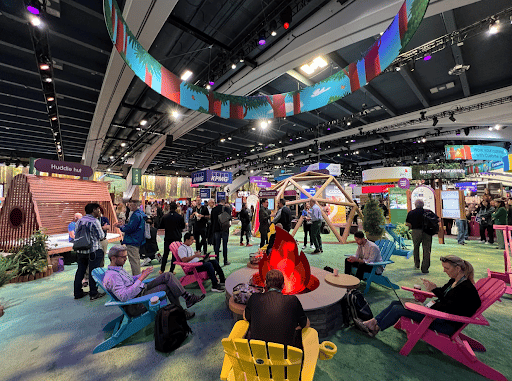 Dreamforce 2022 Tradeshow floor with people sitting around a campfire