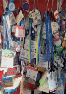 a wall of event badges, lanyards, and even sunglasses